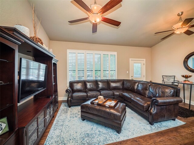 living room with lofted ceiling, hardwood / wood-style floors, and ceiling fan