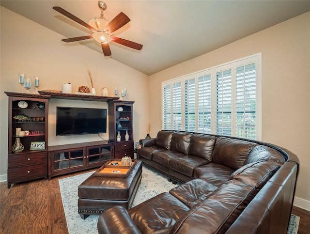 living area featuring a ceiling fan, lofted ceiling, baseboards, and wood finished floors