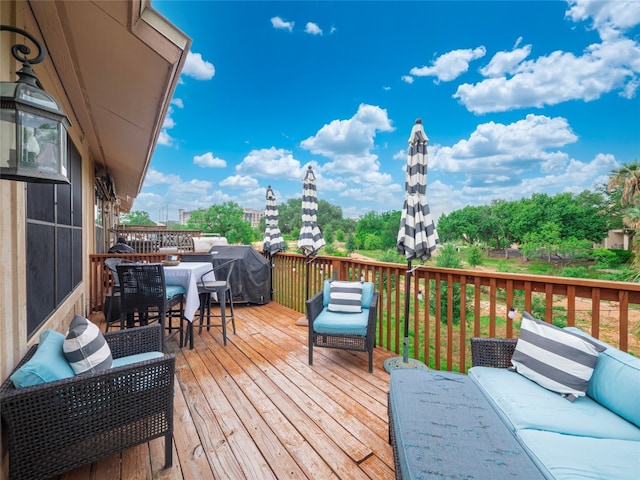 wooden deck featuring area for grilling and outdoor lounge area