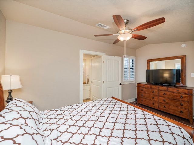 bedroom featuring vaulted ceiling, ceiling fan, ensuite bathroom, and hardwood / wood-style flooring