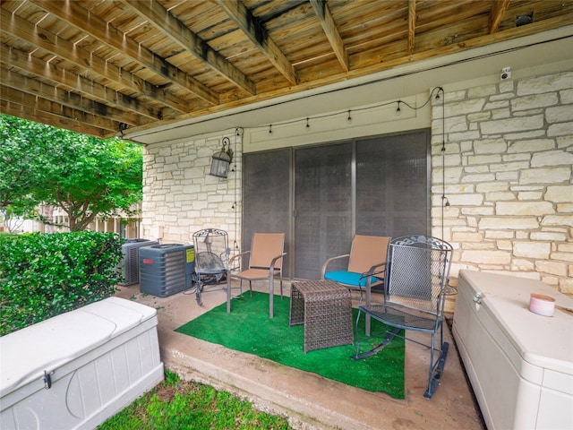 view of patio / terrace with washer / clothes dryer and central AC unit