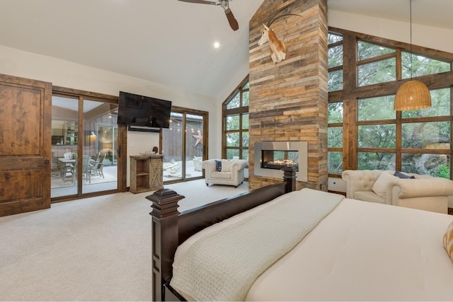 carpeted bedroom with high vaulted ceiling, a fireplace, access to outside, and multiple windows