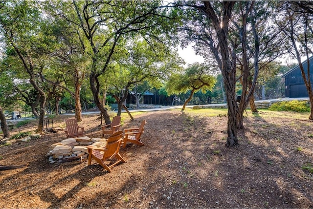 view of yard with an outdoor fire pit