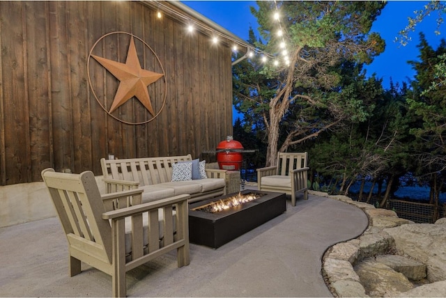 view of patio / terrace with an outdoor living space with a fire pit