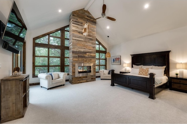 carpeted bedroom featuring multiple windows, ceiling fan, a fireplace, and high vaulted ceiling