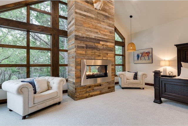 carpeted living room featuring high vaulted ceiling and a stone fireplace