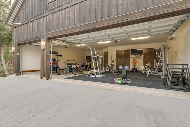 garage featuring an AC wall unit and a garage door opener