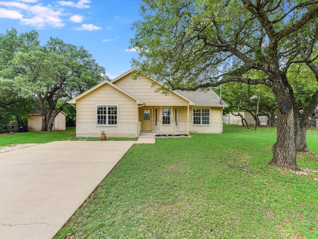 ranch-style home with a storage shed and a front yard