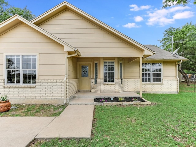 bungalow-style home with a front yard