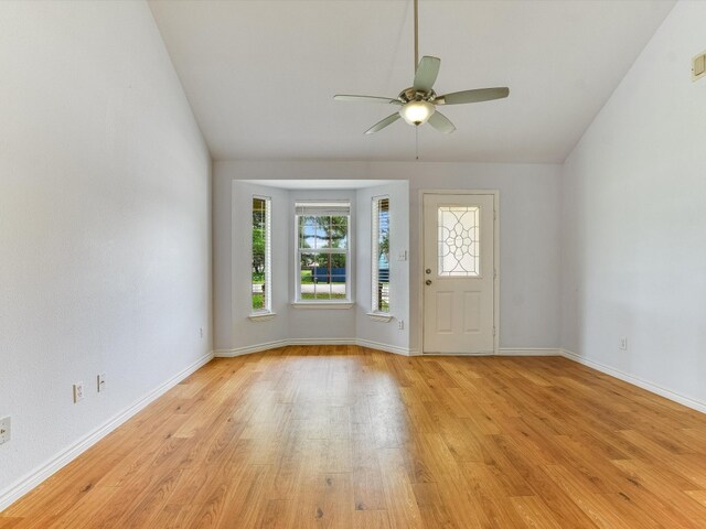 entrance foyer with vaulted ceiling, ceiling fan, and light wood-type flooring