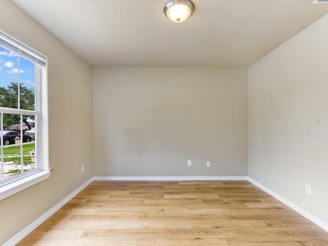 unfurnished room with plenty of natural light and light hardwood / wood-style flooring