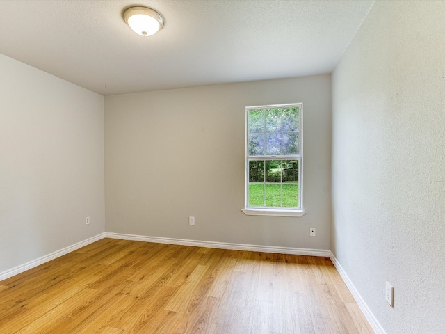 spare room featuring light hardwood / wood-style floors