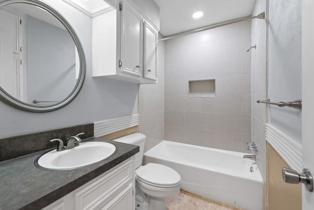 full bathroom with vanity, tile patterned flooring, tiled shower / bath combo, and toilet