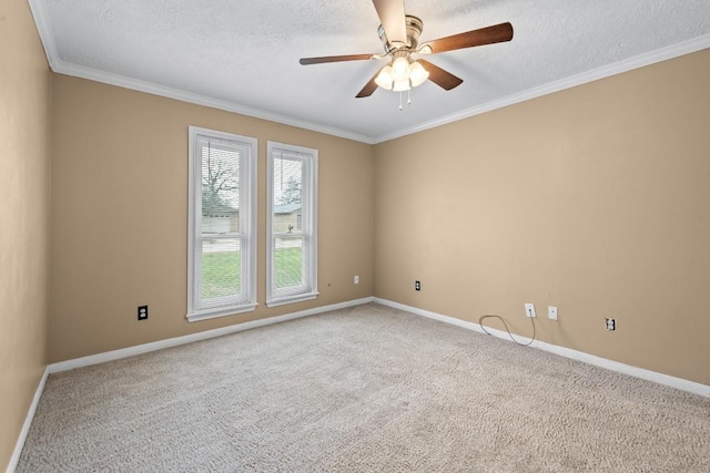 spare room with ceiling fan, crown molding, carpet floors, and a textured ceiling