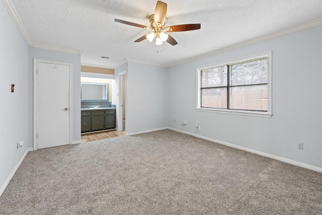 unfurnished bedroom with crown molding, light colored carpet, ceiling fan, and a textured ceiling