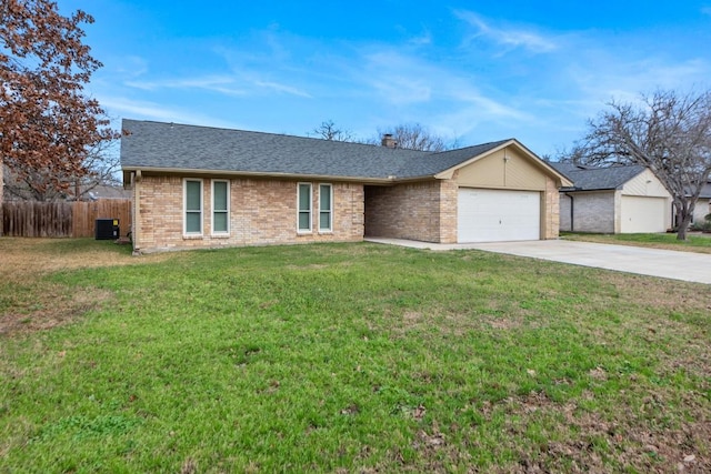 ranch-style house featuring central AC, a garage, and a front yard