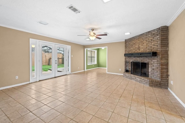 unfurnished living room featuring light tile patterned floors, a fireplace, ornamental molding, and a textured ceiling