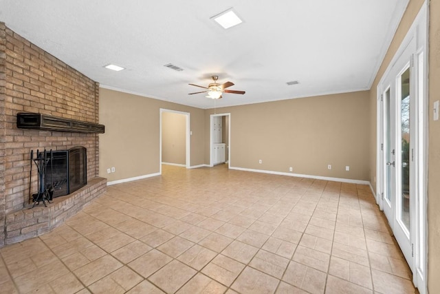 unfurnished living room with light tile patterned flooring, ceiling fan, ornamental molding, and a brick fireplace