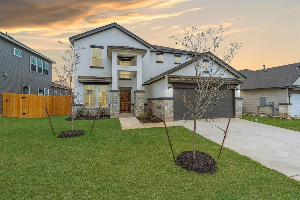 view of front of property with a yard and a garage