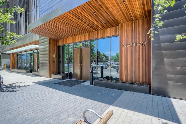 doorway to property with faux log siding