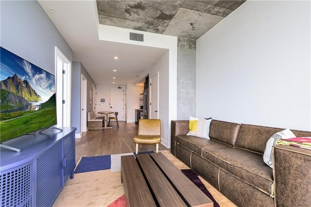 living area with wood finished floors and visible vents