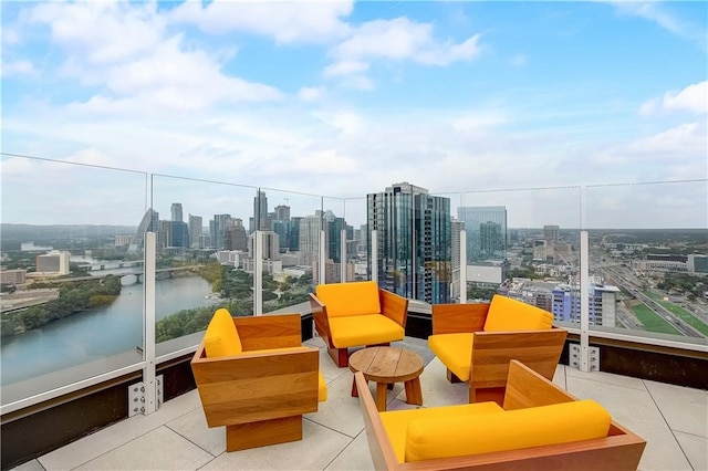 balcony featuring a water view and a city view