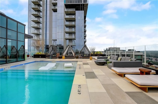 pool featuring a fire pit and a patio