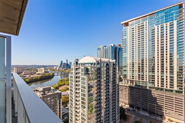 balcony featuring a water view and a city view