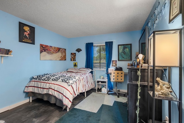 269 Venture Blvd S, Leander, TX 78645 - bedroom with a textured ceiling, baseboards, and wood finished floors