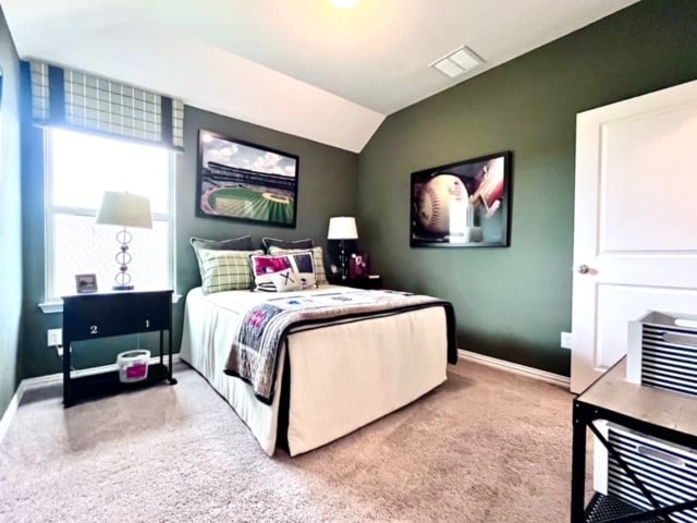 bedroom with carpet flooring and vaulted ceiling