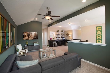 living room with light carpet, ceiling fan, and vaulted ceiling