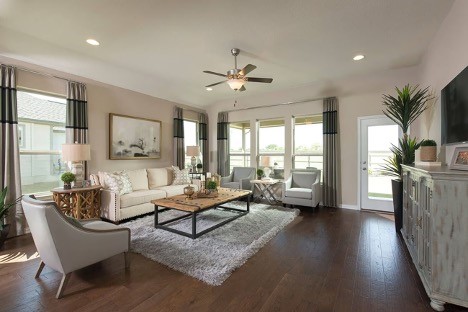 living room featuring ceiling fan and dark wood-type flooring