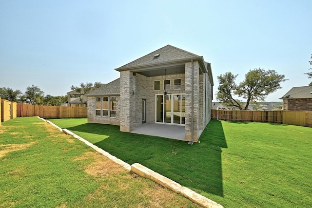 rear view of property with a patio area and a yard