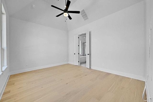 empty room with light hardwood / wood-style floors, vaulted ceiling, and ceiling fan