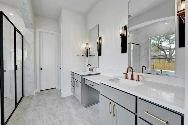 bathroom with vanity and a shower with door