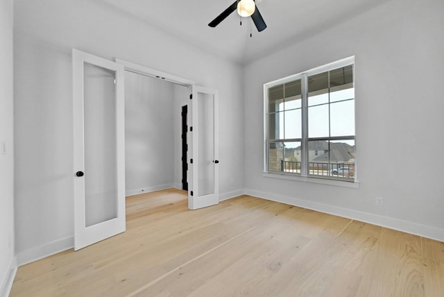 unfurnished bedroom with french doors, light wood-type flooring, and ceiling fan