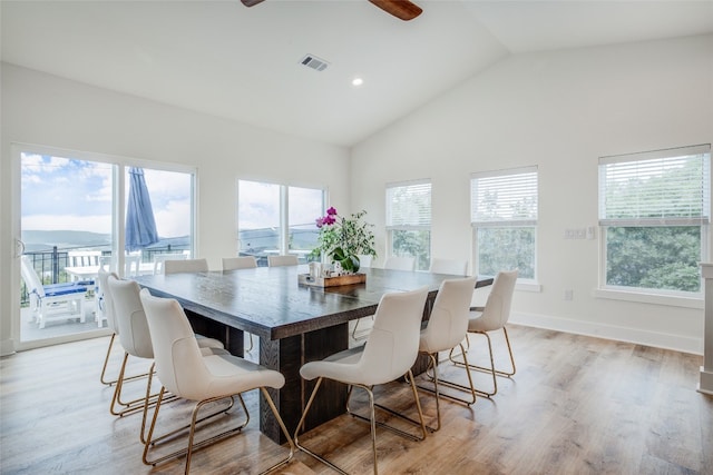 dining space featuring high vaulted ceiling, light wood-type flooring, and ceiling fan