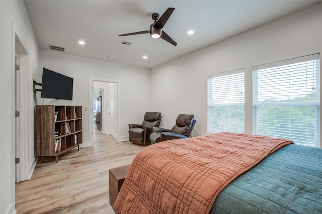 bedroom with light hardwood / wood-style floors and ceiling fan