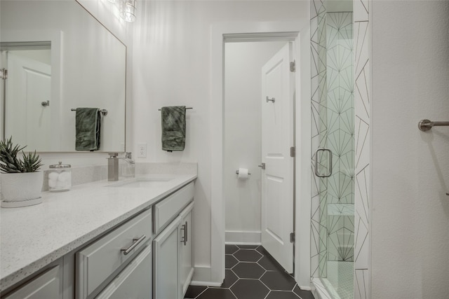 bathroom with tile patterned floors, a shower with shower door, and vanity