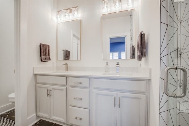 bathroom with vanity, tile patterned flooring, and toilet