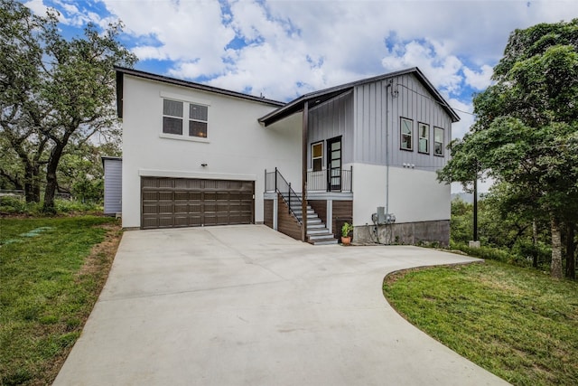 view of front of home with a front yard and a garage