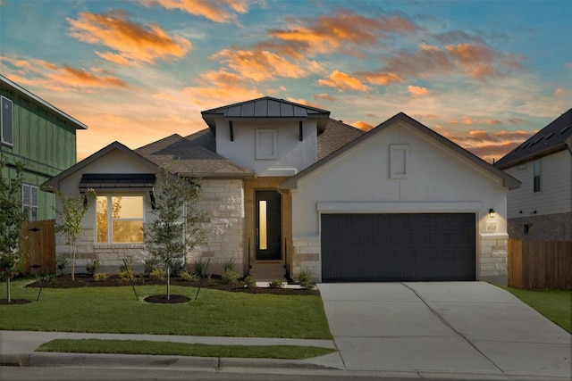 view of front of house with a yard and a garage