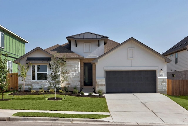 view of front of property with a garage and a front yard