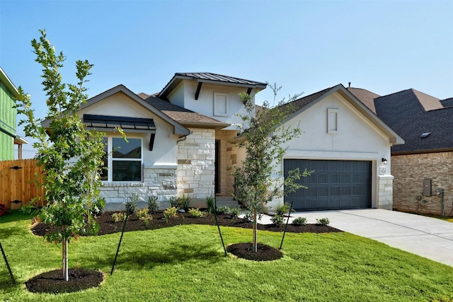 view of front of property with a front lawn and a garage