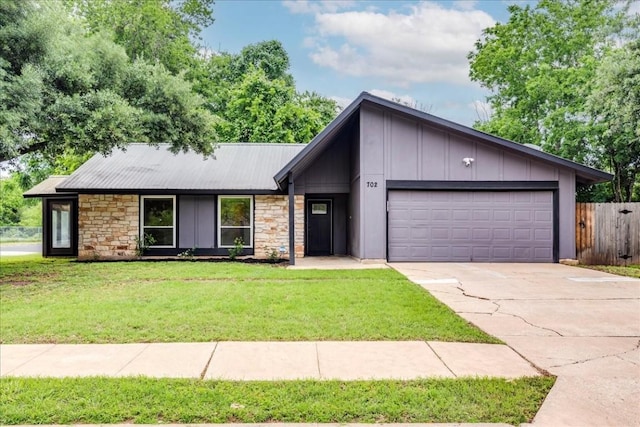 ranch-style home with a garage and a front yard