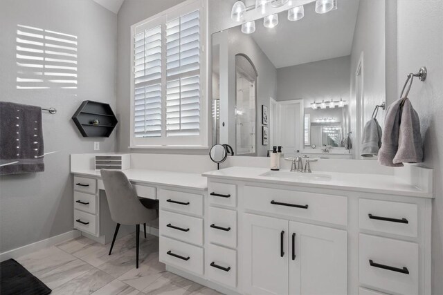 bathroom featuring vanity, vaulted ceiling, a healthy amount of sunlight, and tile patterned flooring