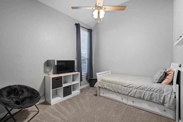 carpeted bedroom featuring ceiling fan and vaulted ceiling