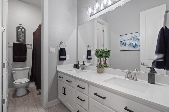 bathroom featuring vanity and toilet