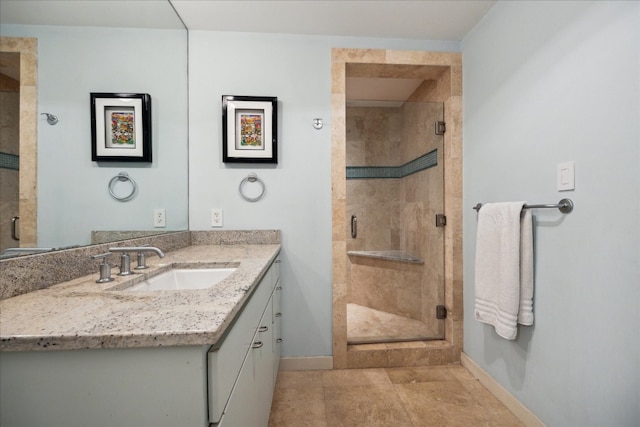 bathroom with walk in shower and vanity