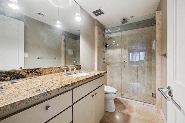 bathroom with toilet, an enclosed shower, and vanity